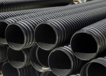 PVC tubes plastic pipes stacked in rows at a construction site on reconstruction of the city drain system